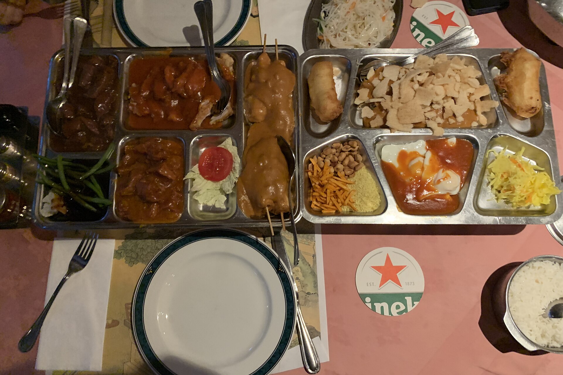 A modern rijsttafel spread of small Indonesian dishes served at a Dutch Chinese-Indonesian restaurant